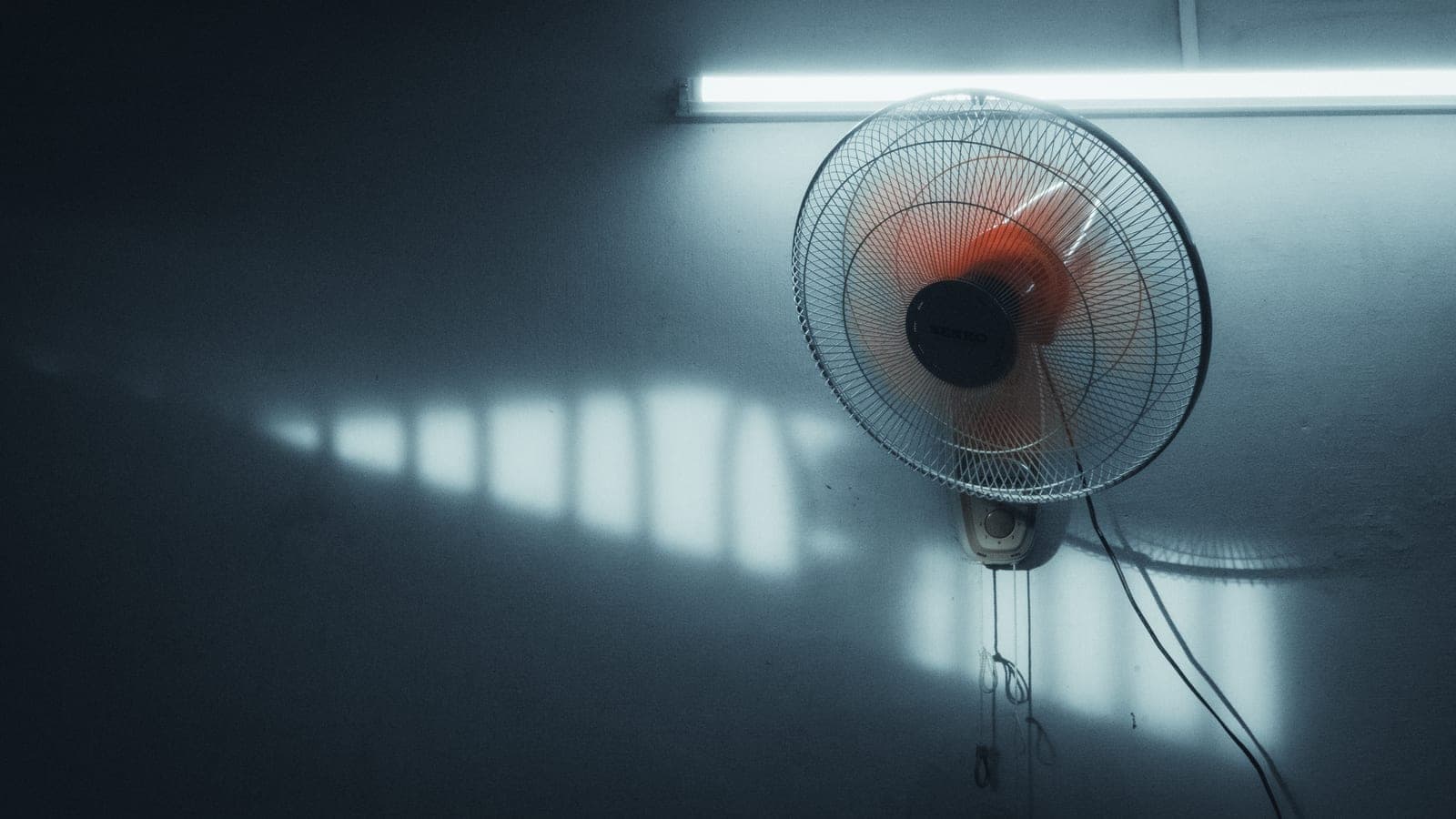An electric fan in a bright minimal room