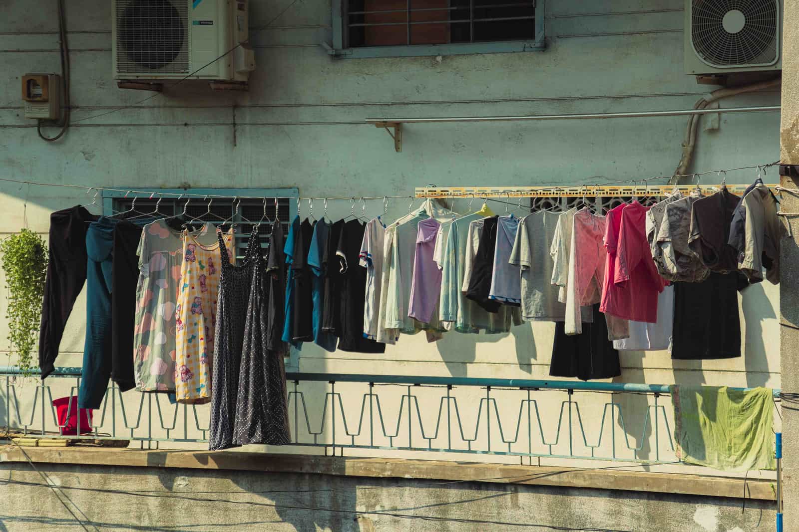 Shirts hanging to dry indoors near a bright window