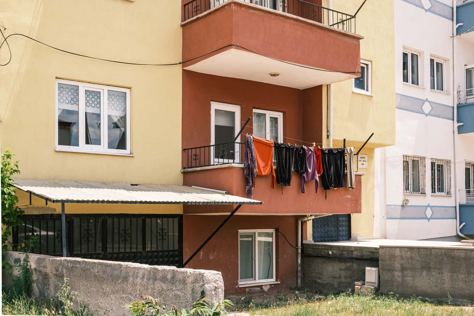 A small apartment balcony with laundry hanging out to dry